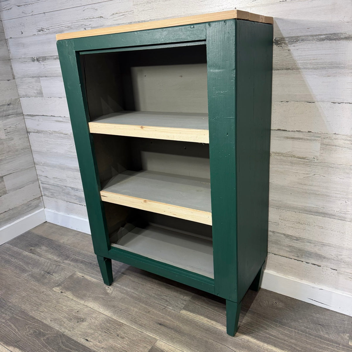 Green refinished bookshelf angled view