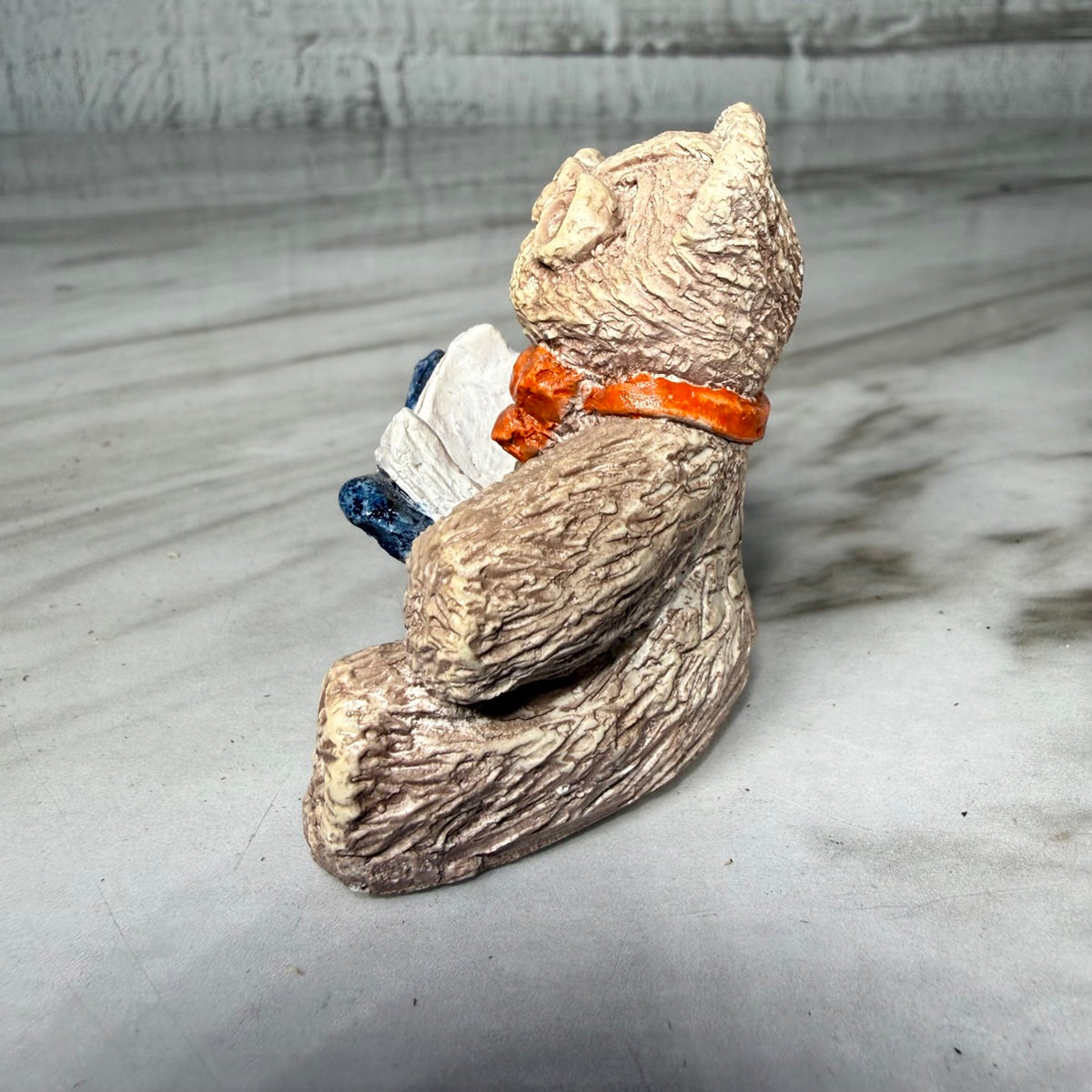 Bear reading figurine, side view