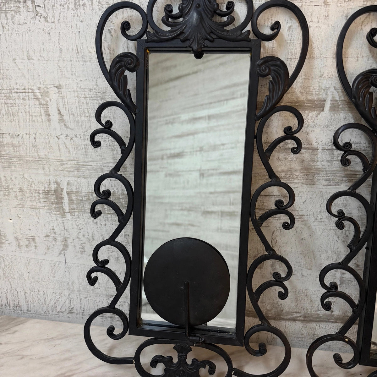 Single wrought iron mirror sconce, front view
