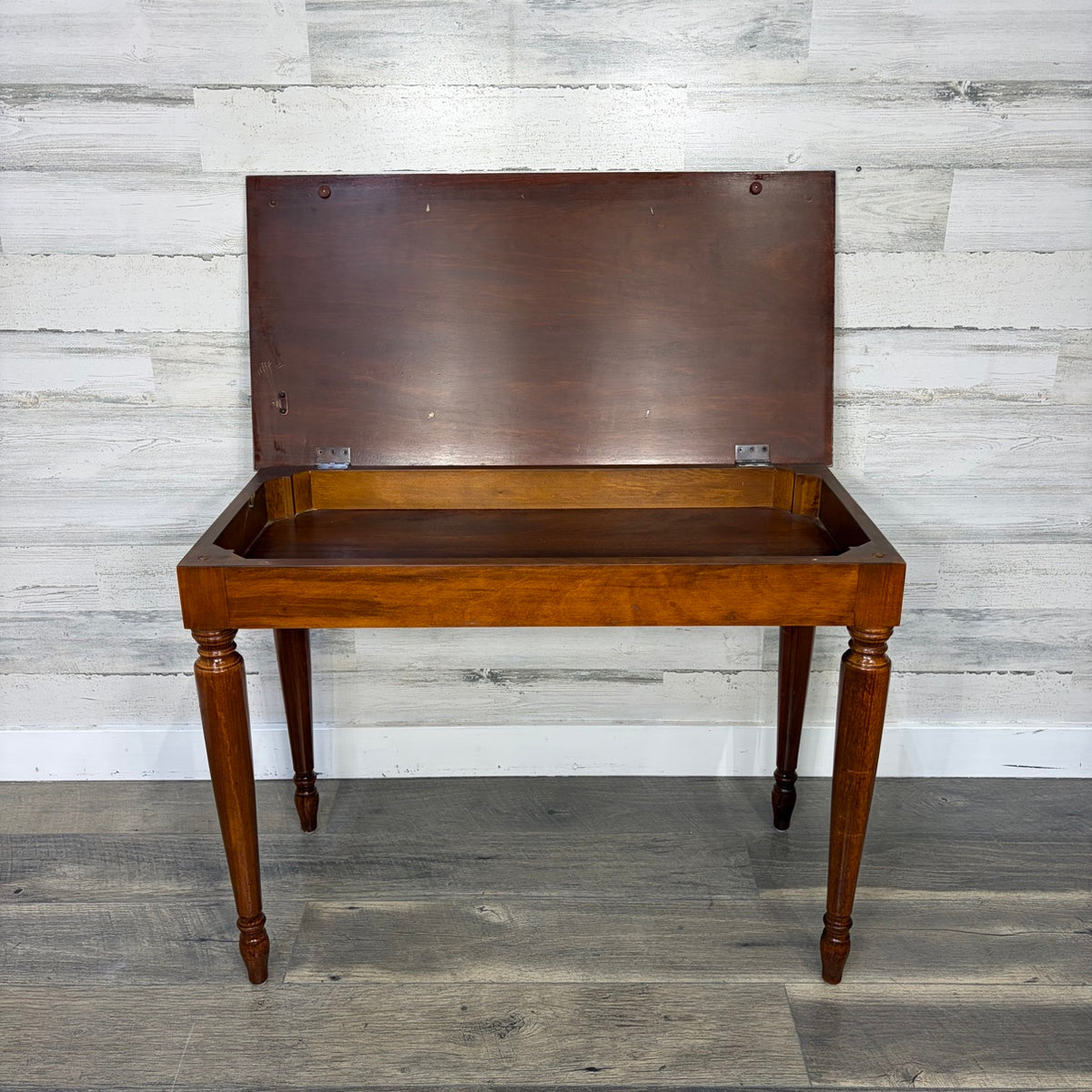Piano bench with storage compartment open