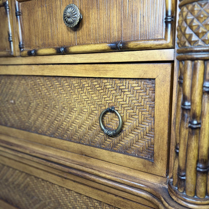 Closeup of ring pull handle, woven rattan drawer, and carved bamboo-style column