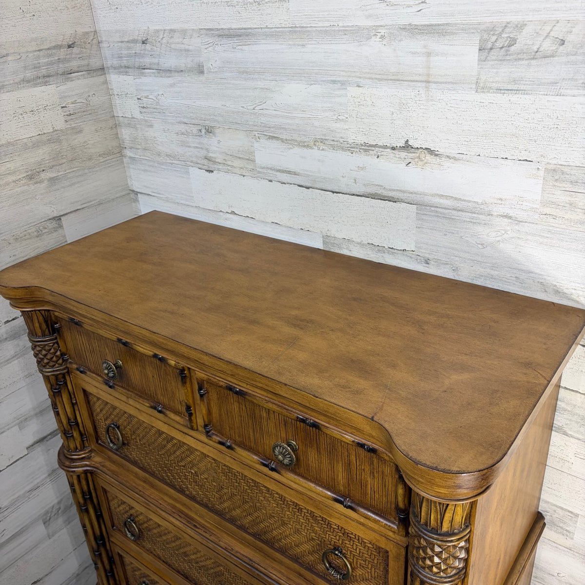 Compass-rose medallion closeup showing minor edge wear on nightstand top