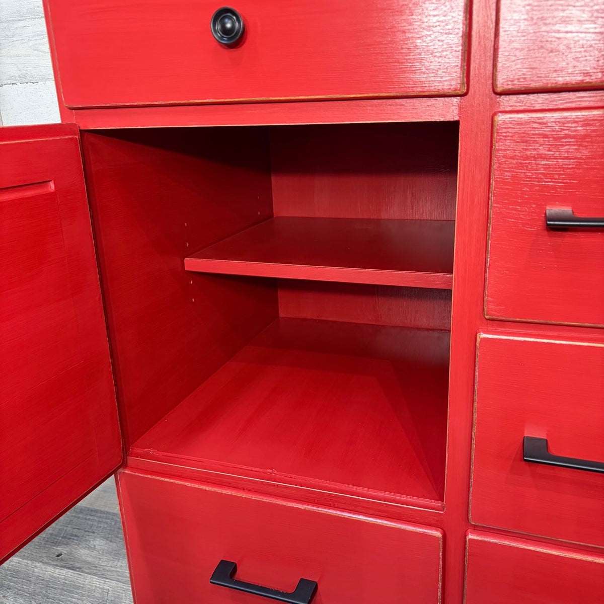 Louvered door cabinet interior with shelf